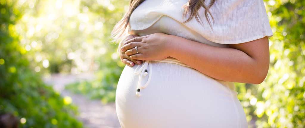 Pregnant Woman hands resting on belly